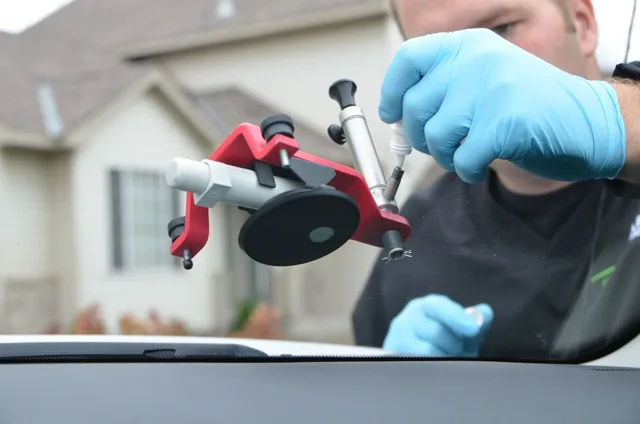Auto expert performing glass repair in Birmingham